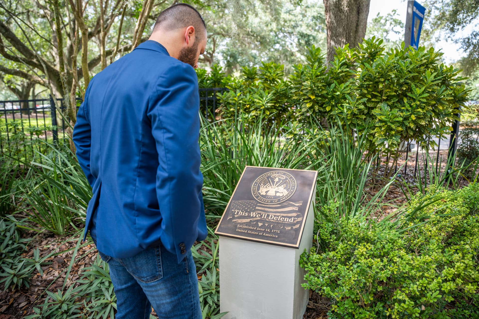 Austin Arthur reading a United States Army memorial plaque while filming in West Orange County, Florida