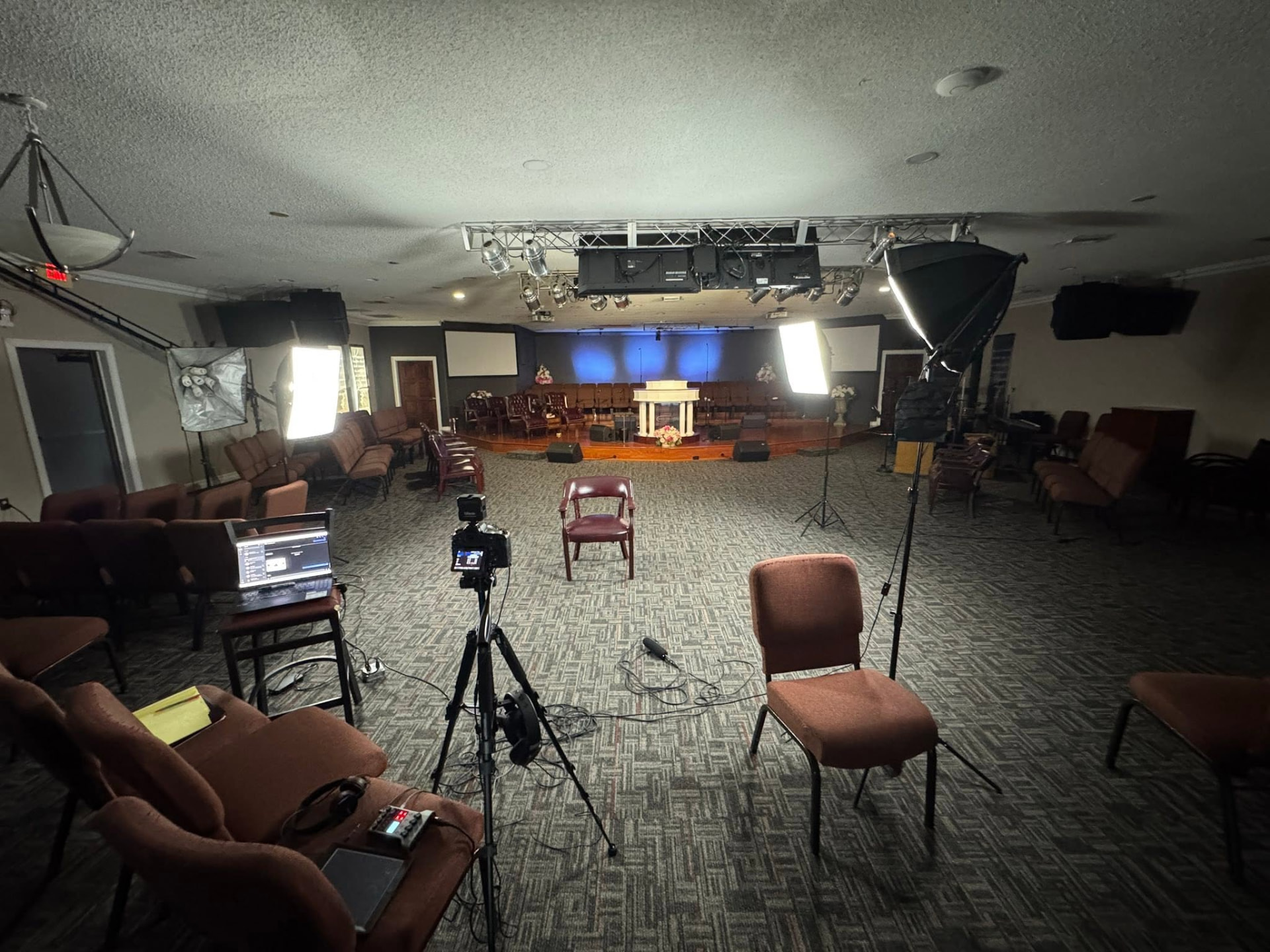 Documentary interview set inside a community room, with cameras, lighting, and chairs arranged for filming They Call Us East Winter Garden in Winter Garden, Florida