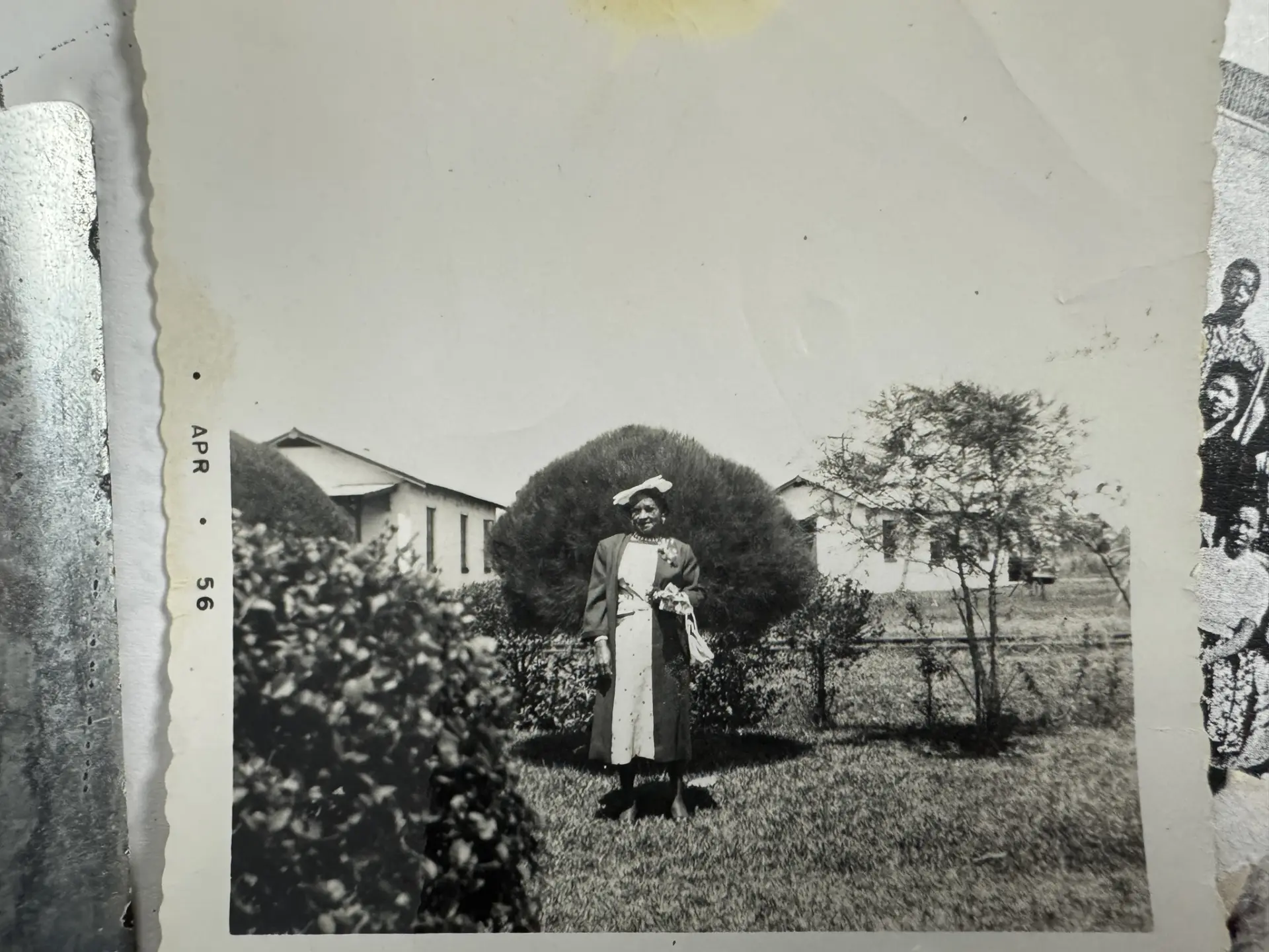 A 1956 photograph of an East Winter Garden resident standing in her yard