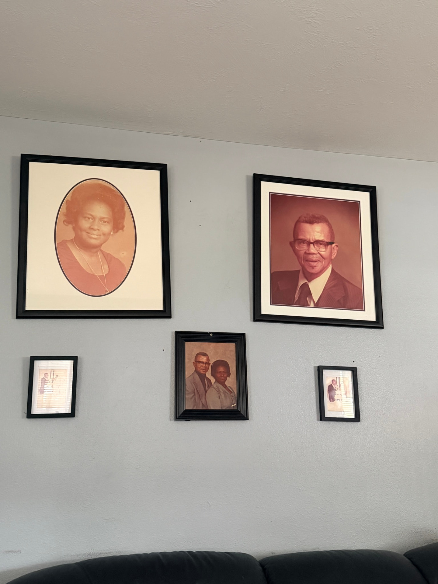 Framed family portraits and historic photographs on a wall in the Historic East Winter Garden Neighborhood, Winter Garden, Florida