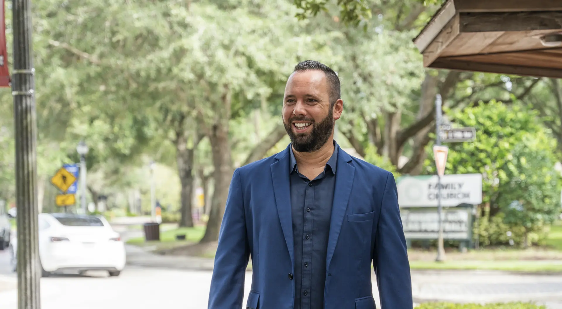 Austin Arthur walking a tree-lined sidewalk in downtown West Orange County, Florida